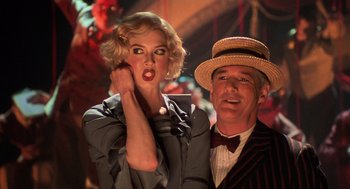 Movie still from “Chicago” (2002), directed by Rob Marshall – A man and a woman posing for a picture; Close Up shot, Low angle