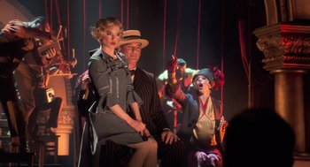 Movie still from “Chicago” (2002), directed by Rob Marshall – A group of people in costume on a stage; Medium shot, Over the shoulder angle