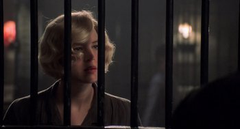 Movie still from “Chicago” (2002), directed by Rob Marshall – A woman standing behind bars in front of a window; Close Up shot, Over the shoulder angle