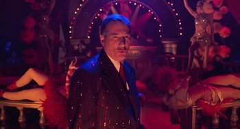 Movie still from “Chicago” (2002), directed by Rob Marshall – A man wearing a suit and tie in a dark room; Medium shot, Low angle