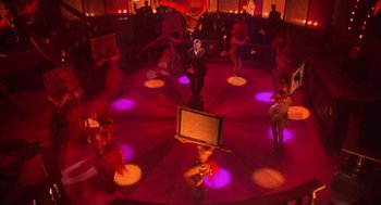 Movie still from “Chicago” (2002), directed by Rob Marshall – A group of people dancing in a circle in a room; Wide shot, High angle