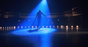 Movie still from “Chicago” (2002), directed by Rob Marshall – A man standing on a stage in the middle of the night; Wide shot, Low angle