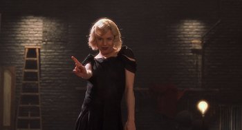 Movie still from “Chicago” (2002), directed by Rob Marshall – A woman in a black dress pointing to the side; Medium shot, Over the shoulder angle