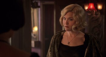 Movie still from “Chicago” (2002), directed by Rob Marshall – A woman with blonde hair wearing a black top; Close Up shot, Over the shoulder angle