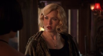 Movie still from “Chicago” (2002), directed by Rob Marshall – A woman with blonde hair wearing a black top; Close Up shot, Over the shoulder angle