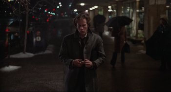 Movie still from “Chilly Scenes of Winter” (1979), directed by Joan Micklin Silver – A man standing in the middle of a street; Medium shot, High angle