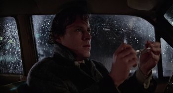 Movie still from “Chilly Scenes of Winter” (1979), directed by Joan Micklin Silver – A man sitting in the driver's seat of a car in the snow; Close Up shot, Low angle
