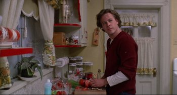 Movie still from “Chilly Scenes of Winter” (1979), directed by Joan Micklin Silver – A man in a red shirt is in the kitchen cutting tomatoes; Close Up shot, Low angle