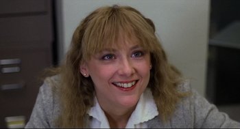 Movie still from “Chilly Scenes of Winter” (1979), directed by Joan Micklin Silver – A person smiling for the camera; Close Up shot, Low angle