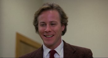 Movie still from “Chilly Scenes of Winter” (1979), directed by Joan Micklin Silver – A person wearing a suit and smiling; Close Up shot, Low angle