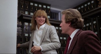Movie still from “Chilly Scenes of Winter” (1979), directed by Joan Micklin Silver – A woman and a man in a suit and tie in a room; Medium shot, Low angle