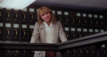 Movie still from “Chilly Scenes of Winter” (1979), directed by Joan Micklin Silver – A woman standing in front of a row of filing cabinets; Medium shot, Low angle