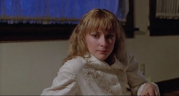 Movie still from “Chilly Scenes of Winter” (1979), directed by Joan Micklin Silver – A woman in a white shirt is posing for a picture; Close Up shot, Low angle