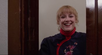Movie still from “Chilly Scenes of Winter” (1979), directed by Joan Micklin Silver – A woman smiling for the camera wearing a blue and red outfit; Close Up shot, Low angle