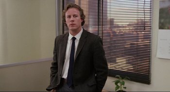 Movie still from “Chilly Scenes of Winter” (1979), directed by Joan Micklin Silver – A man in a suit standing in front of a window; Medium shot, Over the shoulder angle