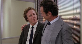 Movie still from “Chilly Scenes of Winter” (1979), directed by Joan Micklin Silver – Two men in business suits standing next to each other; Medium shot, Over the shoulder angle