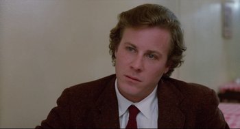 Movie still from “Chilly Scenes of Winter” (1979), directed by Joan Micklin Silver – A man wearing a suit and tie looking at the camera; Close Up shot, Over the shoulder angle