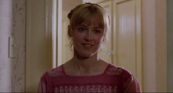 Movie still from “Chilly Scenes of Winter” (1979), directed by Joan Micklin Silver – A woman in a pink shirt smiling for the camera; Close Up shot, Over the shoulder angle