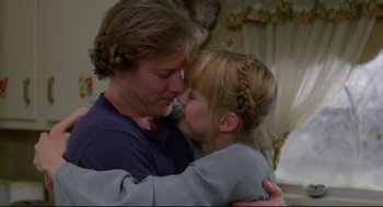 Movie still from “Chilly Scenes of Winter” (1979), directed by Joan Micklin Silver – A man and a girl are hugging each other; Medium shot, Over the shoulder angle