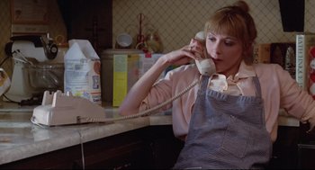 Movie still from “Chilly Scenes of Winter” (1979), directed by Joan Micklin Silver – A woman sitting at a counter talking on a phone; Medium shot, Low angle