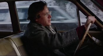 Movie still from “Chilly Scenes of Winter” (1979), directed by Joan Micklin Silver – A man driving a car on a snowy day; Close Up shot, Over the shoulder angle