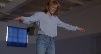 Movie still from “Chilly Scenes of Winter” (1979), directed by Joan Micklin Silver – A woman in blue jeans and a white shirt is dancing; Medium shot, Low angle