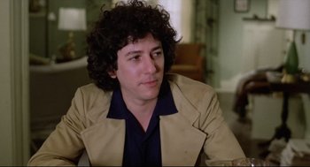 Movie still from “Chilly Scenes of Winter” (1979), directed by Joan Micklin Silver – A man with curly brown hair sitting in a room; Close Up shot, Low angle