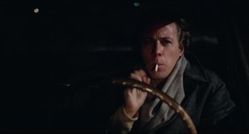 Movie still from “Chilly Scenes of Winter” (1979), directed by Joan Micklin Silver – A man smoking a cigarette while holding a steering wheel; Close Up shot, Low angle