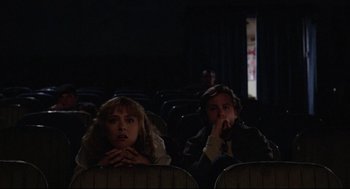 Movie still from “Chilly Scenes of Winter” (1979), directed by Joan Micklin Silver – A couple of people that are sitting in a movie theater; Medium shot, Low angle
