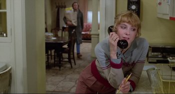 Movie still from “Chilly Scenes of Winter” (1979), directed by Joan Micklin Silver – A woman talking on a phone while holding a pencil; Medium shot, Low angle