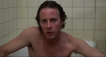 Movie still from “Chilly Scenes of Winter” (1979), directed by Joan Micklin Silver – A shirtless man sitting in a tub in front of a tiled wall; Close Up shot, Low angle