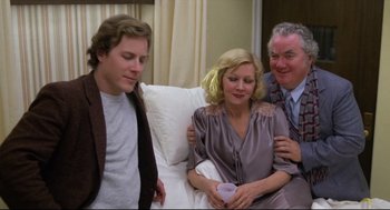 Movie still from “Chilly Scenes of Winter” (1979), directed by Joan Micklin Silver – Two men and a woman sitting on a white couch; Medium shot, Over the shoulder angle