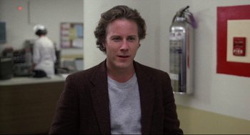 Movie still from “Chilly Scenes of Winter” (1979), directed by Joan Micklin Silver – A man with long hair wearing a jacket; Close Up shot, Over the shoulder angle