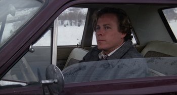 Movie still from “Chilly Scenes of Winter” (1979), directed by Joan Micklin Silver – A man sitting in the driver's seat of a car in the snow; Close Up shot, Over the shoulder angle