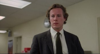 Movie still from “Chilly Scenes of Winter” (1979), directed by Joan Micklin Silver – A man in a suit and tie standing in a room; Close Up shot, Low angle