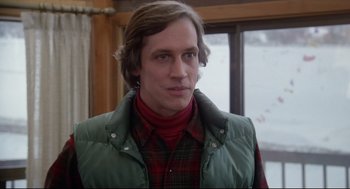 Movie still from “Chilly Scenes of Winter” (1979), directed by Joan Micklin Silver – A man in a plaid shirt and a green vest; Close Up shot, Over the shoulder angle