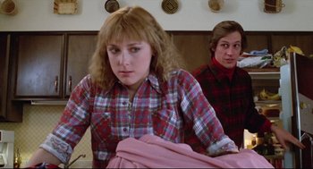 Movie still from “Chilly Scenes of Winter” (1979), directed by Joan Micklin Silver – A woman in a plaid shirt and a man in a red plaid shirt; Medium shot, Low angle