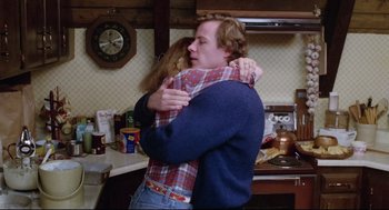 Movie still from “Chilly Scenes of Winter” (1979), directed by Joan Micklin Silver – A man and a woman hugging in a kitchen; Medium shot, Low angle