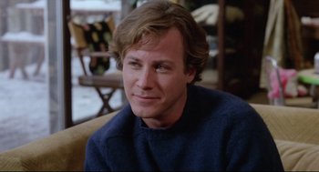 Movie still from “Chilly Scenes of Winter” (1979), directed by Joan Micklin Silver – A person sitting on a couch wearing a sweater; Close Up shot, Over the shoulder angle