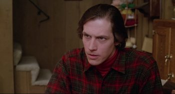 Movie still from “Chilly Scenes of Winter” (1979), directed by Joan Micklin Silver – A man in a red and black plaid shirt looks to his left; Close Up shot, Low angle
