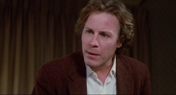 Movie still from “Chilly Scenes of Winter” (1979), directed by Joan Micklin Silver – A person wearing a suit and tie; Close Up shot, Over the shoulder angle