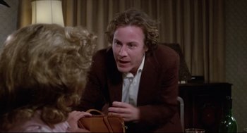 Movie still from “Chilly Scenes of Winter” (1979), directed by Joan Micklin Silver – A man talking to a woman holding a brown purse; Close Up shot, Over the shoulder angle