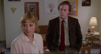 Movie still from “Chilly Scenes of Winter” (1979), directed by Joan Micklin Silver – A man and a woman standing next to each other in a room; Medium shot, Over the shoulder angle