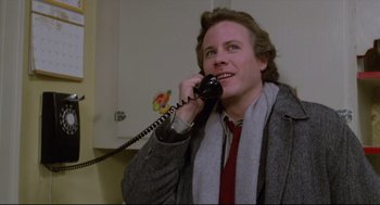 Movie still from “Chilly Scenes of Winter” (1979), directed by Joan Micklin Silver – A man talking on a phone while wearing a jacket; Close Up shot, Low angle