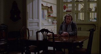 Movie still from “Chilly Scenes of Winter” (1979), directed by Joan Micklin Silver – A woman sitting at a table in a kitchen; Medium shot, High angle