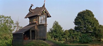 Movie still from “Chitty Chitty Bang Bang” (1968), directed by Ken Hughes – A small wooden house with a window on the top of it; Extreme Wide shot, Low angle