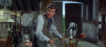 Movie still from “Chitty Chitty Bang Bang” (1968), directed by Ken Hughes – A man wearing a vest and a neck tie; Medium shot, Low angle