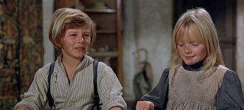 Movie still from “Chitty Chitty Bang Bang” (1968), directed by Ken Hughes – A young boy and a young girl are smiling for the camera; Close Up shot, Low angle