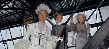Movie still from “Chitty Chitty Bang Bang” (1968), directed by Ken Hughes – A woman and two children dressed up in costumes; Medium shot, Low angle
