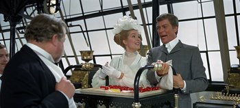 Movie still from “Chitty Chitty Bang Bang” (1968), directed by Ken Hughes – A man and a woman sitting in a carriage; Medium shot, Over the shoulder angle